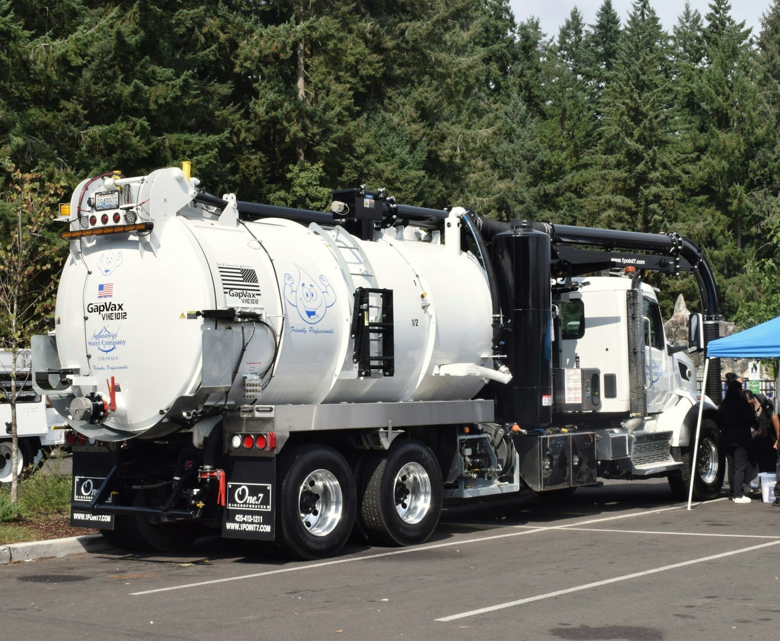 A large white vacuum truck parked outdoors